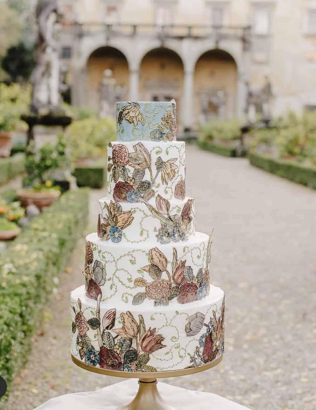 One of a kind wedding cake with hand painted floral design