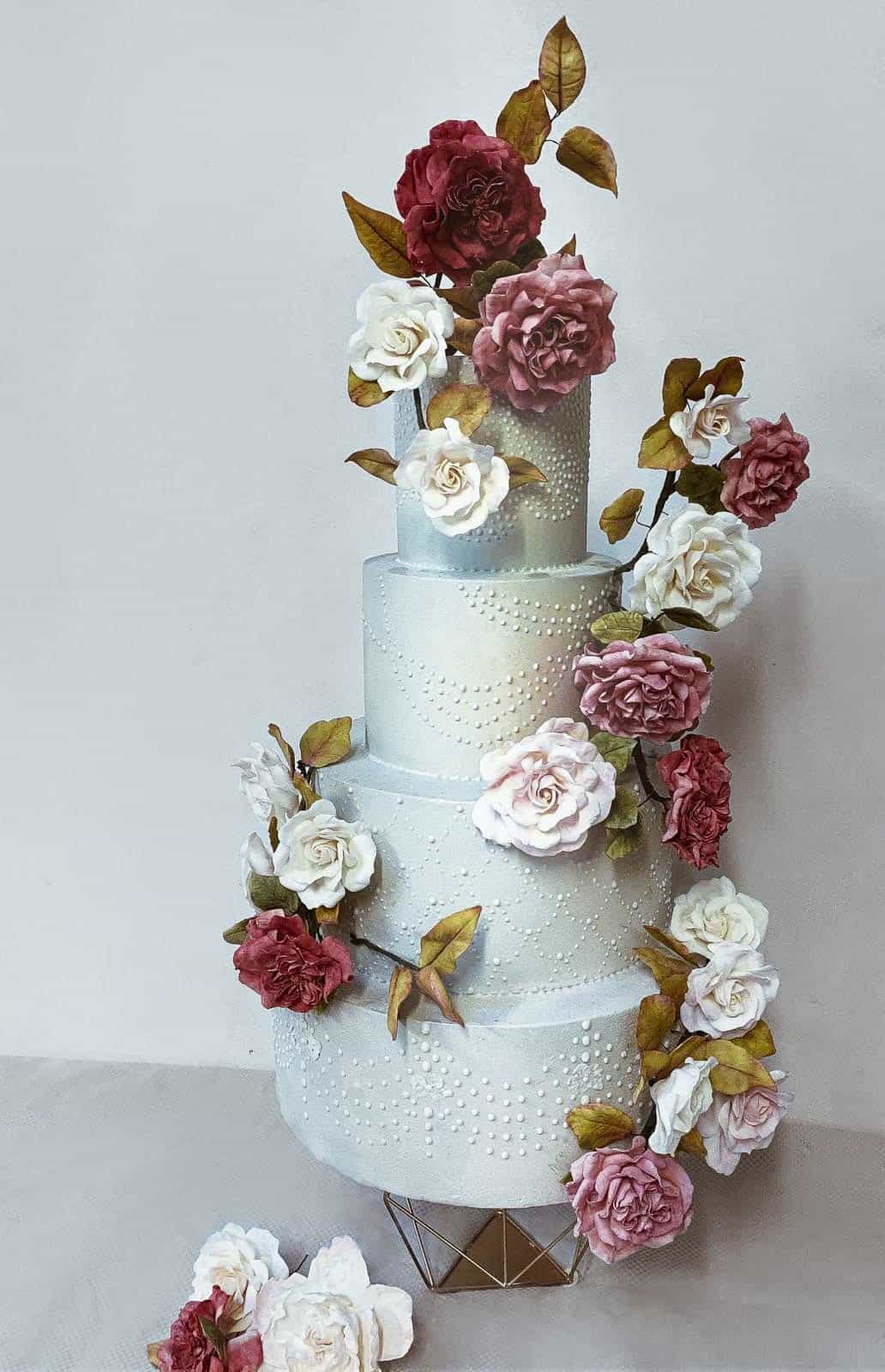 Luxury wedding cake with wild rose design, Tuscan elegance, and intricate details, crafted for a destination wedding in Florence, Italy.
